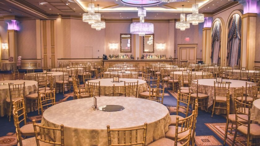 Elegant wedding venue hall decorated with lights and floral arrangements