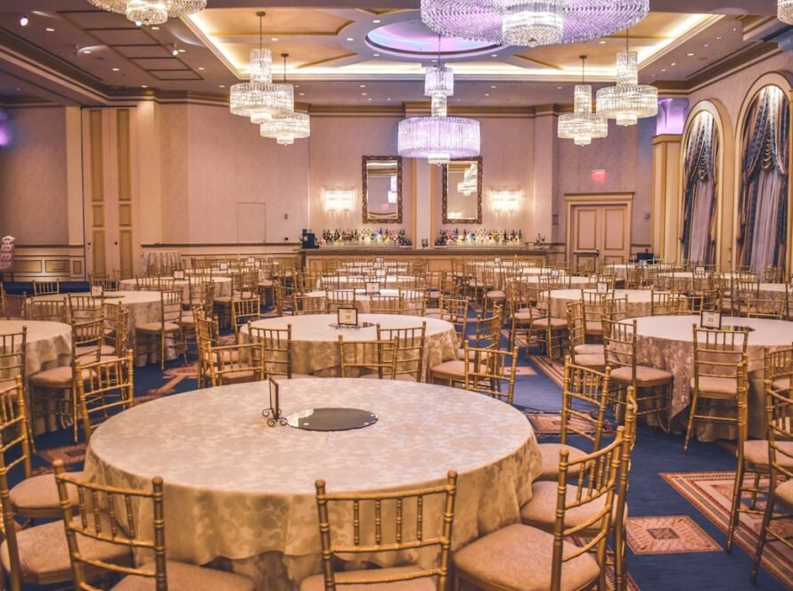Elegant wedding venue hall decorated with lights and floral arrangements