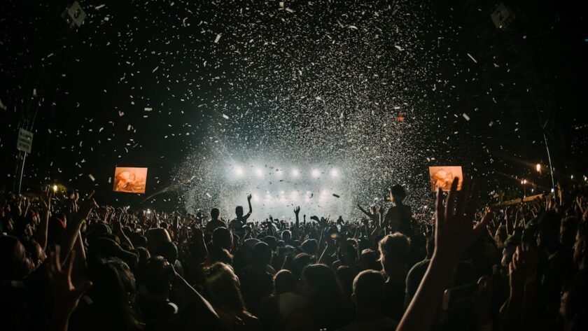 Festive night celebration with stage lighting and dancing crowd