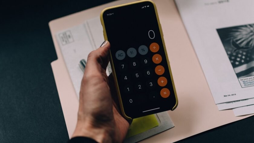 Couple planning their wedding budget with a calculator and notebook