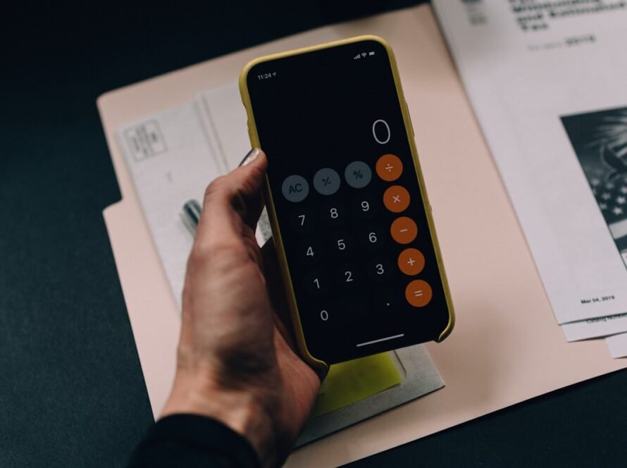 Couple planning their wedding budget with a calculator and notebook